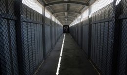 A long hallway view of a detention centre.
