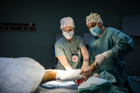 Red Cross workers perform surgery in a Iraq hospital