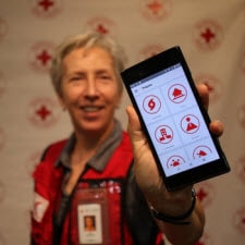 Red Cross Volunteer displaying smartphone with BeReady app