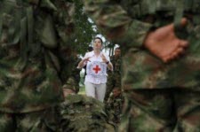 Red Cross worker in front of soldiers