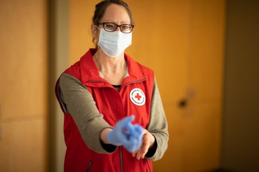 red  cross worker wearing PPE