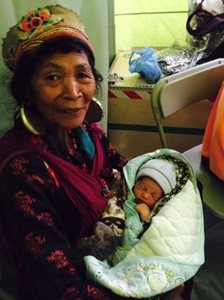 Kanchhi Tamang holds her new baby granddaughter
