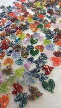 Aileen fabriqué des milliers de petits coeurs en verre soufflé qu’elle distribue à de parfaits inconnus dans l’espoir de les faire sourire